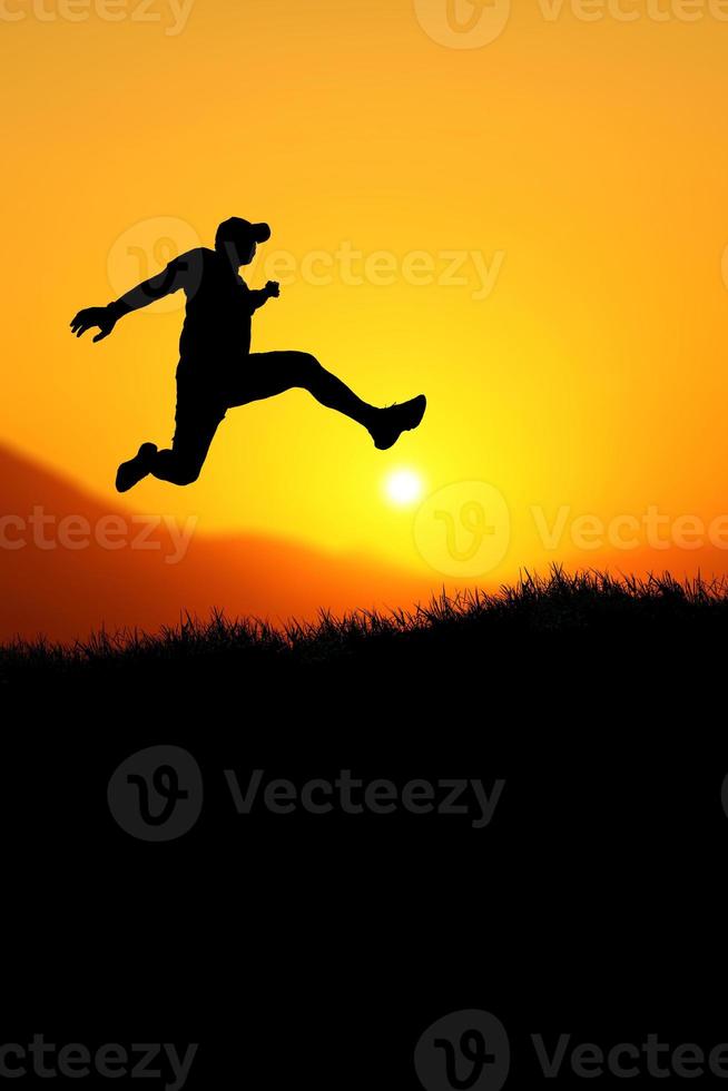 Vertical silhouette of a man jumping to the future. The concept of moving on to something better photo