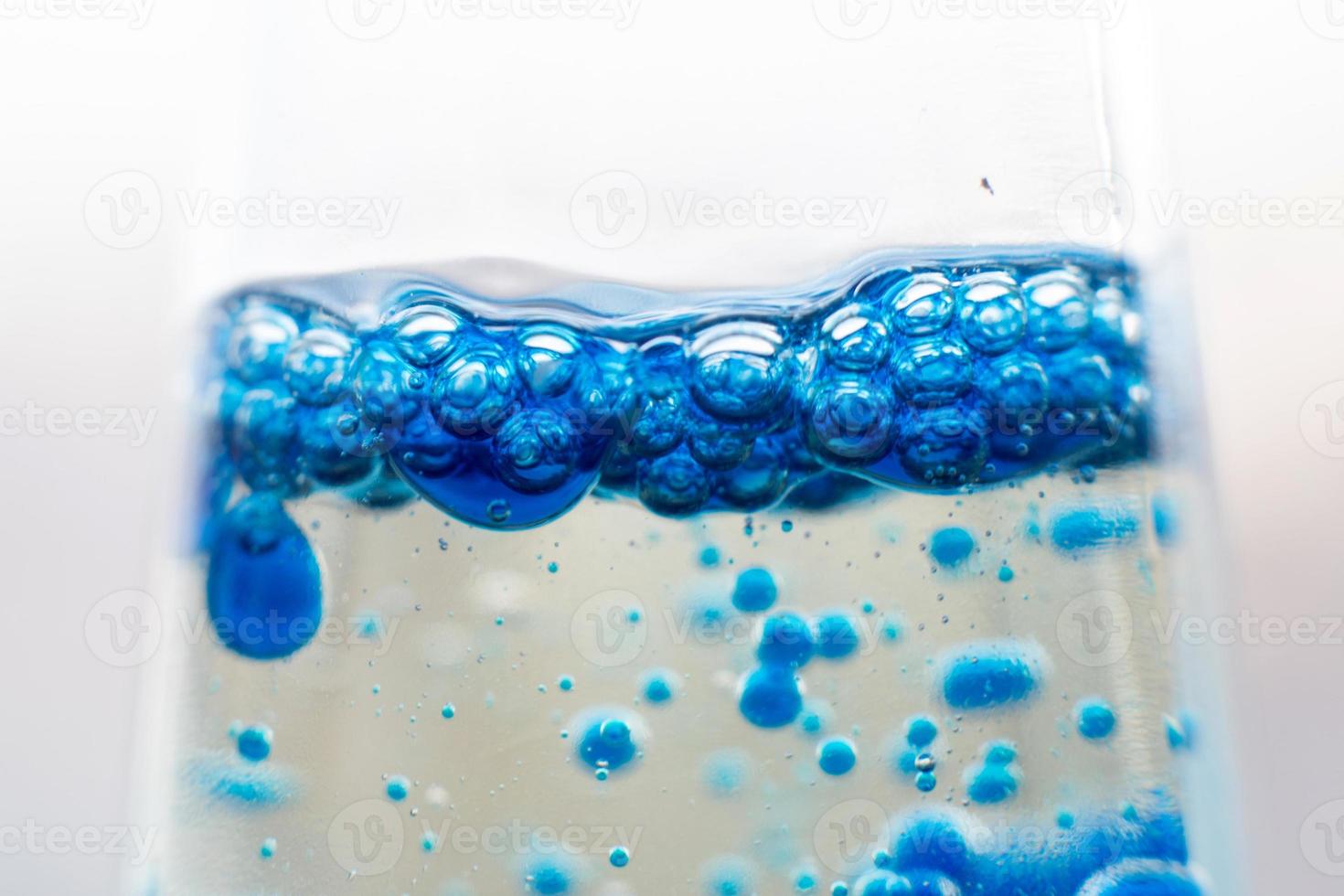 blue bubbles in the glass of water.Blue tone,Abstract Backgrounds photo
