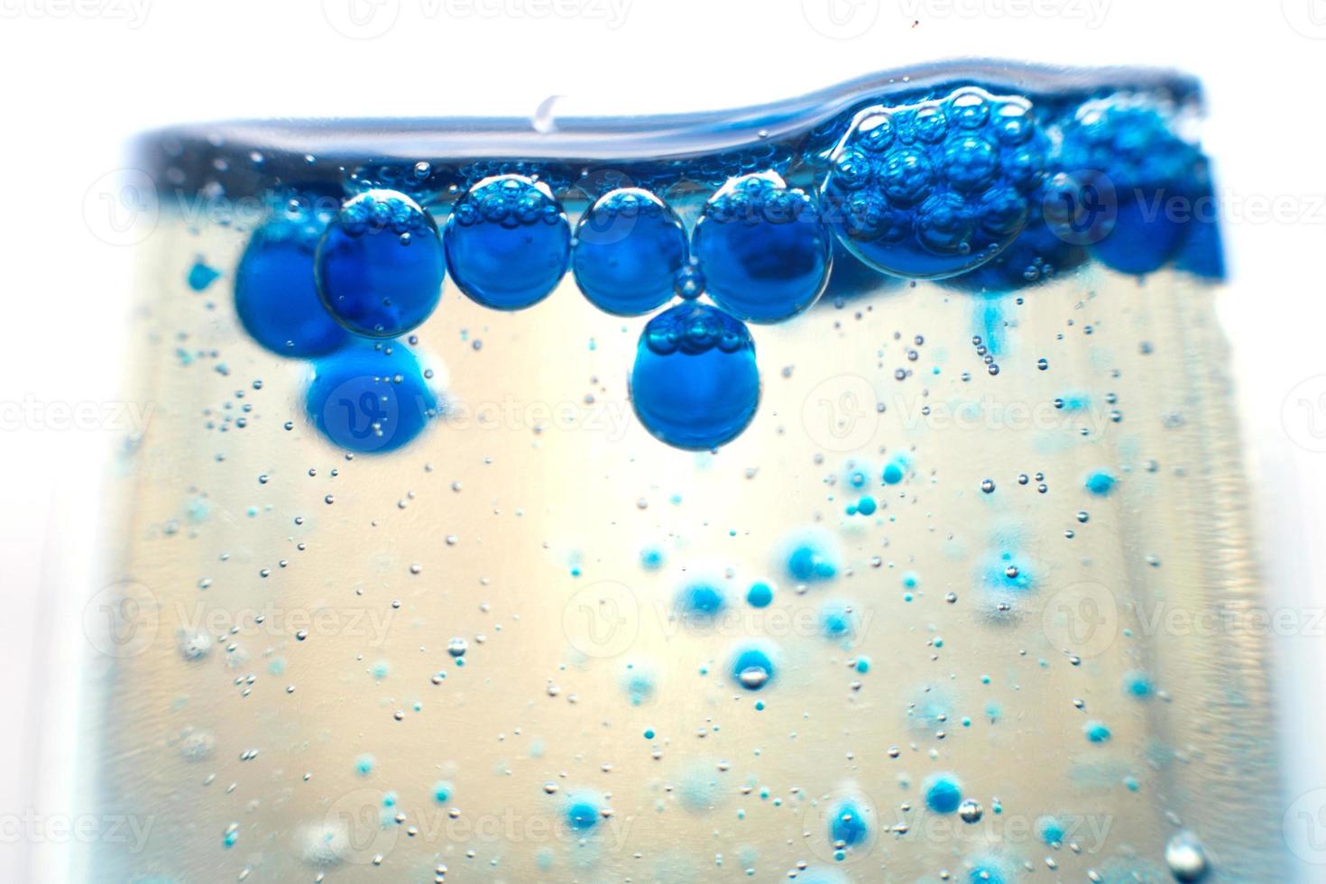 blue bubbles in the glass of water.Blue tone,Abstract Backgrounds photo