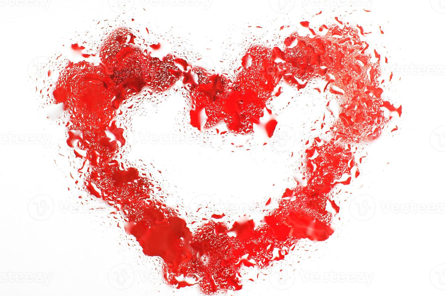 corazón rojo bajo la superficie de vidrio con gotas de agua cerca. fondo de San Valentín, amor, concepto de fecha foto