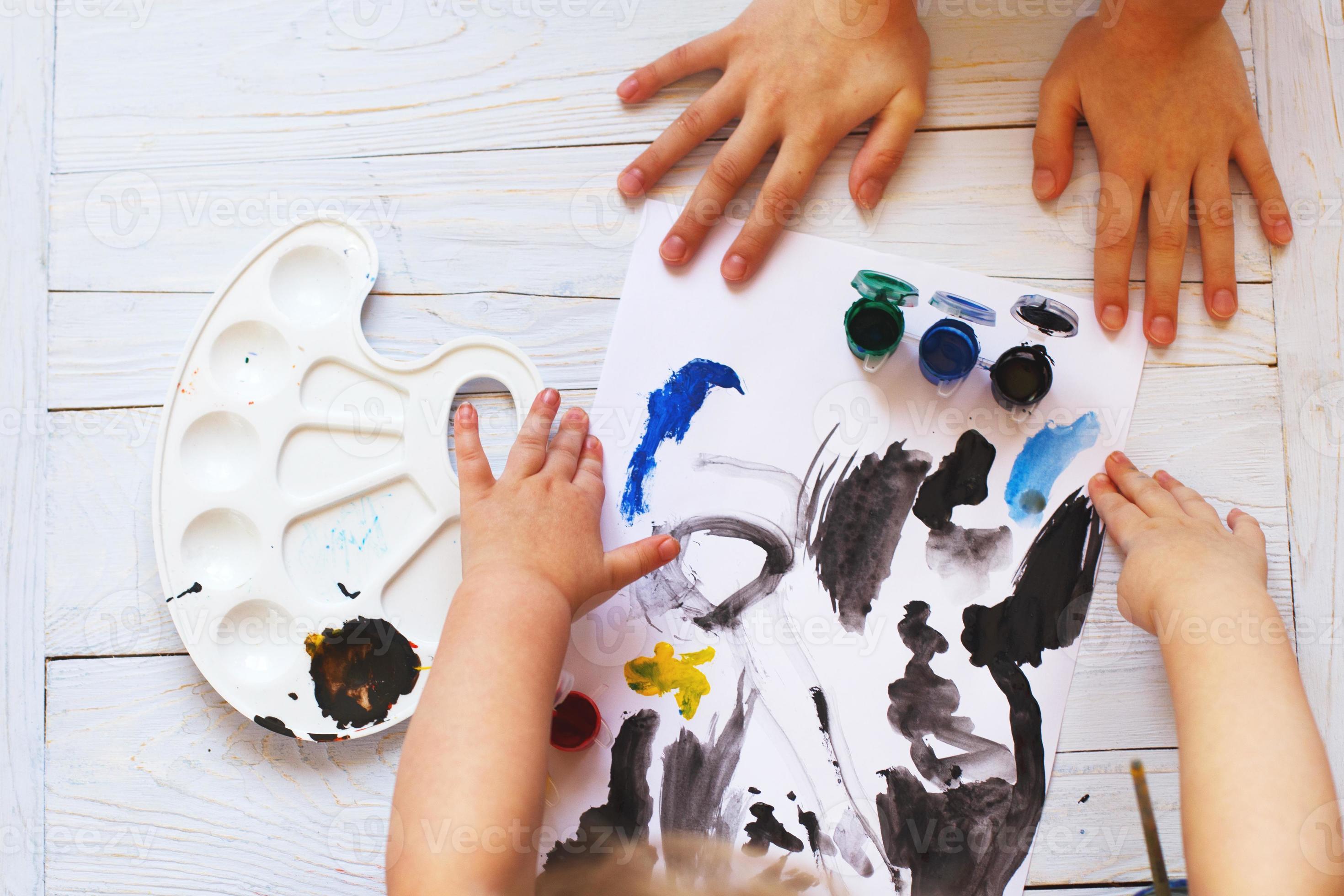 Child drawing top view. Artwork workplace with creative accessories. Flat  lay art tools for painting. Stock Photo by ©soleg 104015220