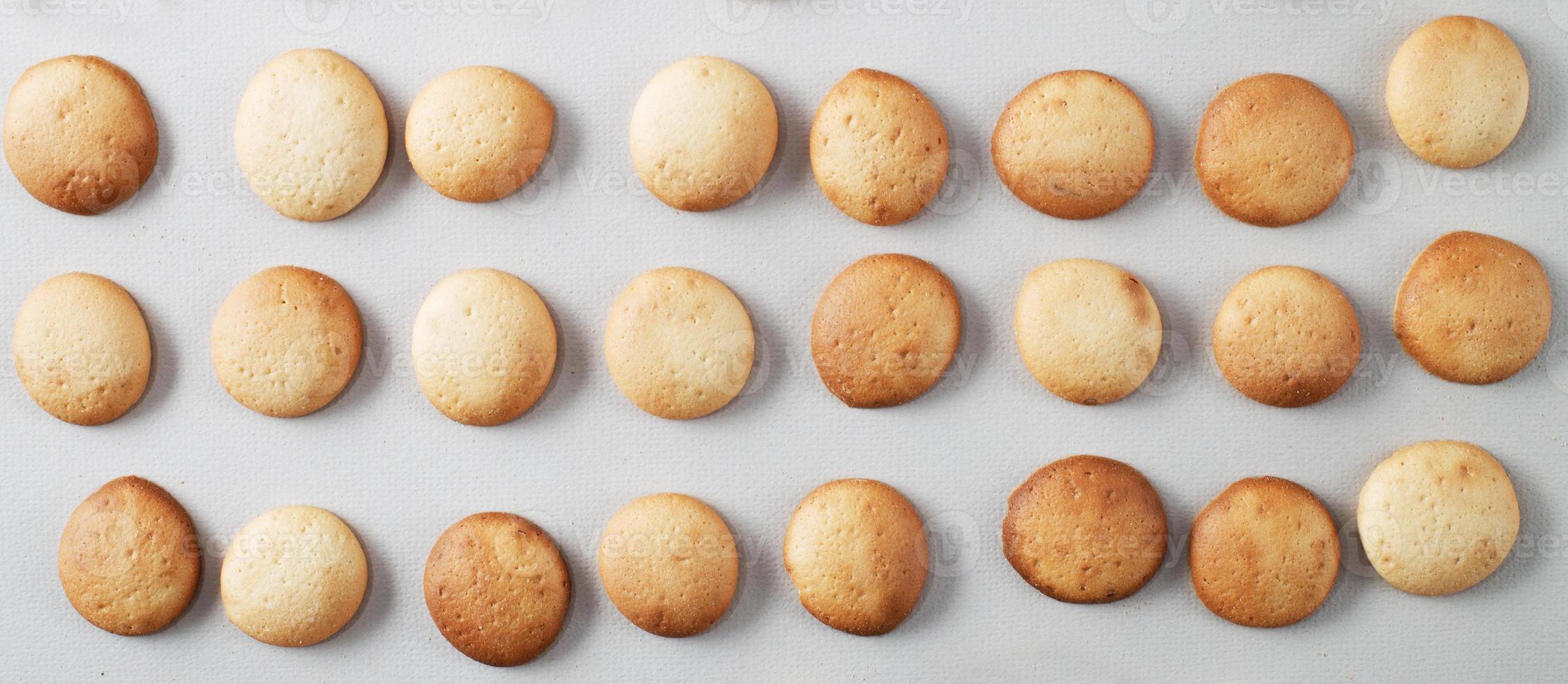 A pattern of small pancakes. Background from orange toasted round biscuits. home bakery. banner photo