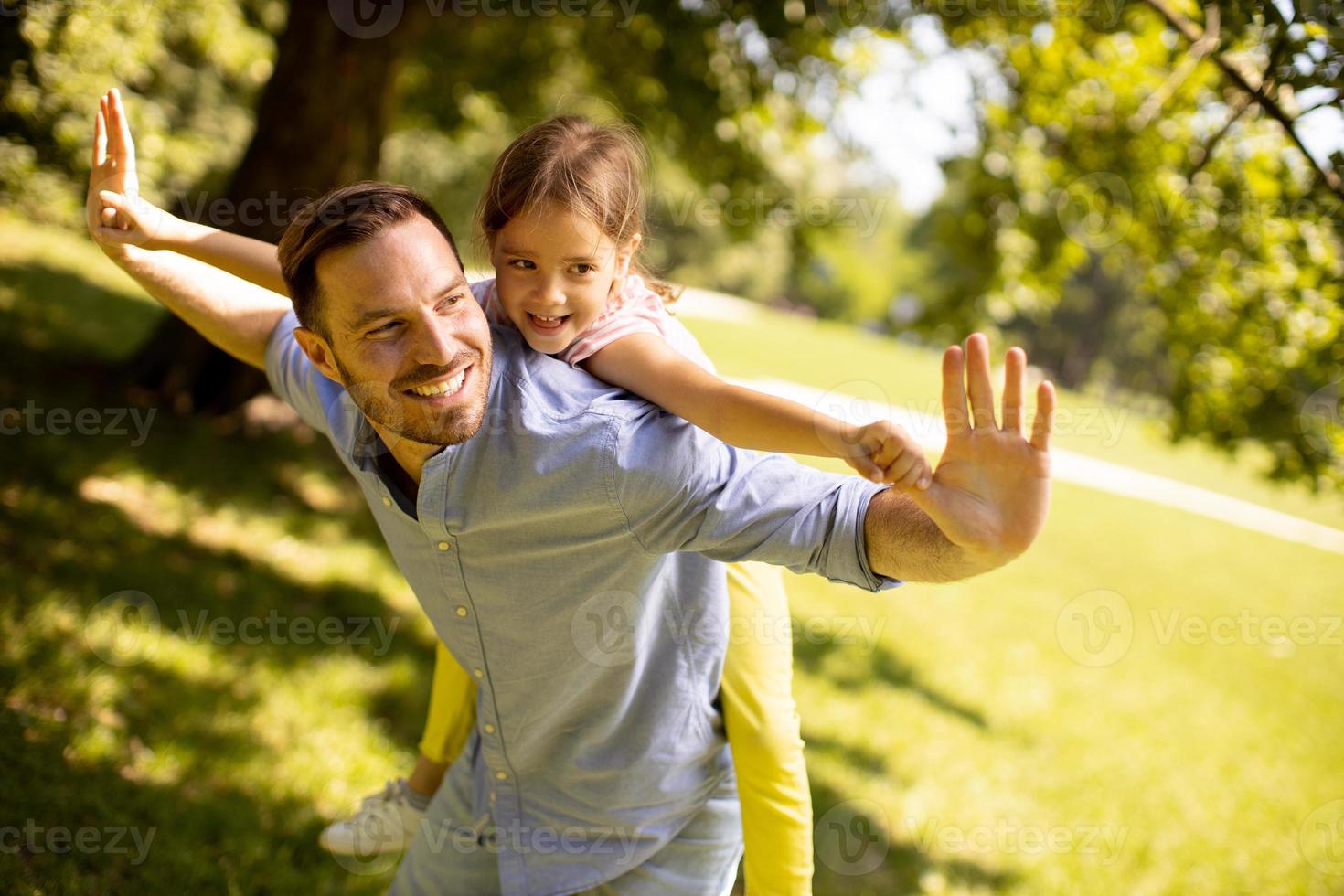 Father with daughter having fun at the park photo