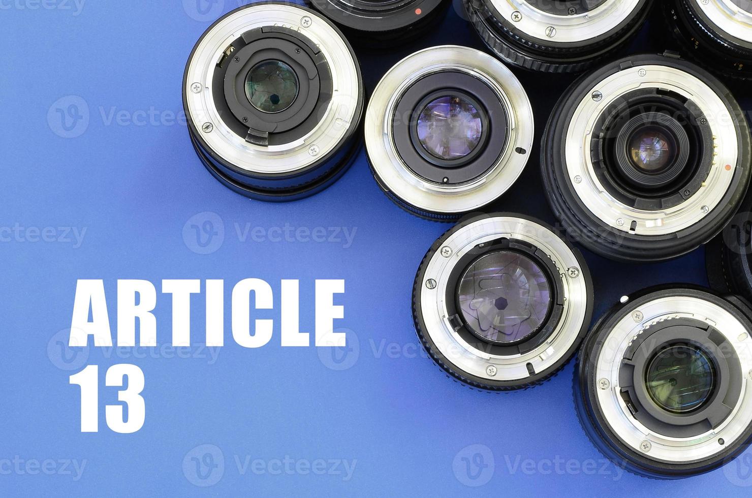 Several photographic lenses and article 13 inscription on blue photo