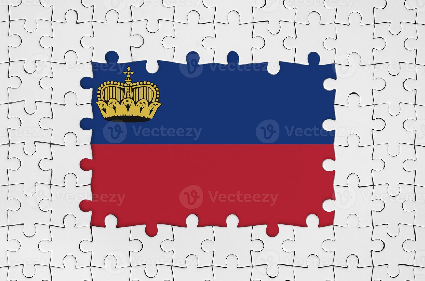 Liechtenstein flag in frame of white puzzle pieces with missing central part photo