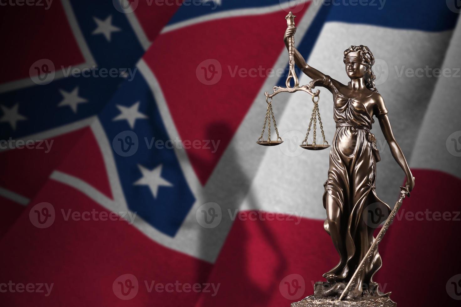 Mississippi new US state flag with statue of lady justice and judicial scales in dark room. Concept of judgement and punishment photo