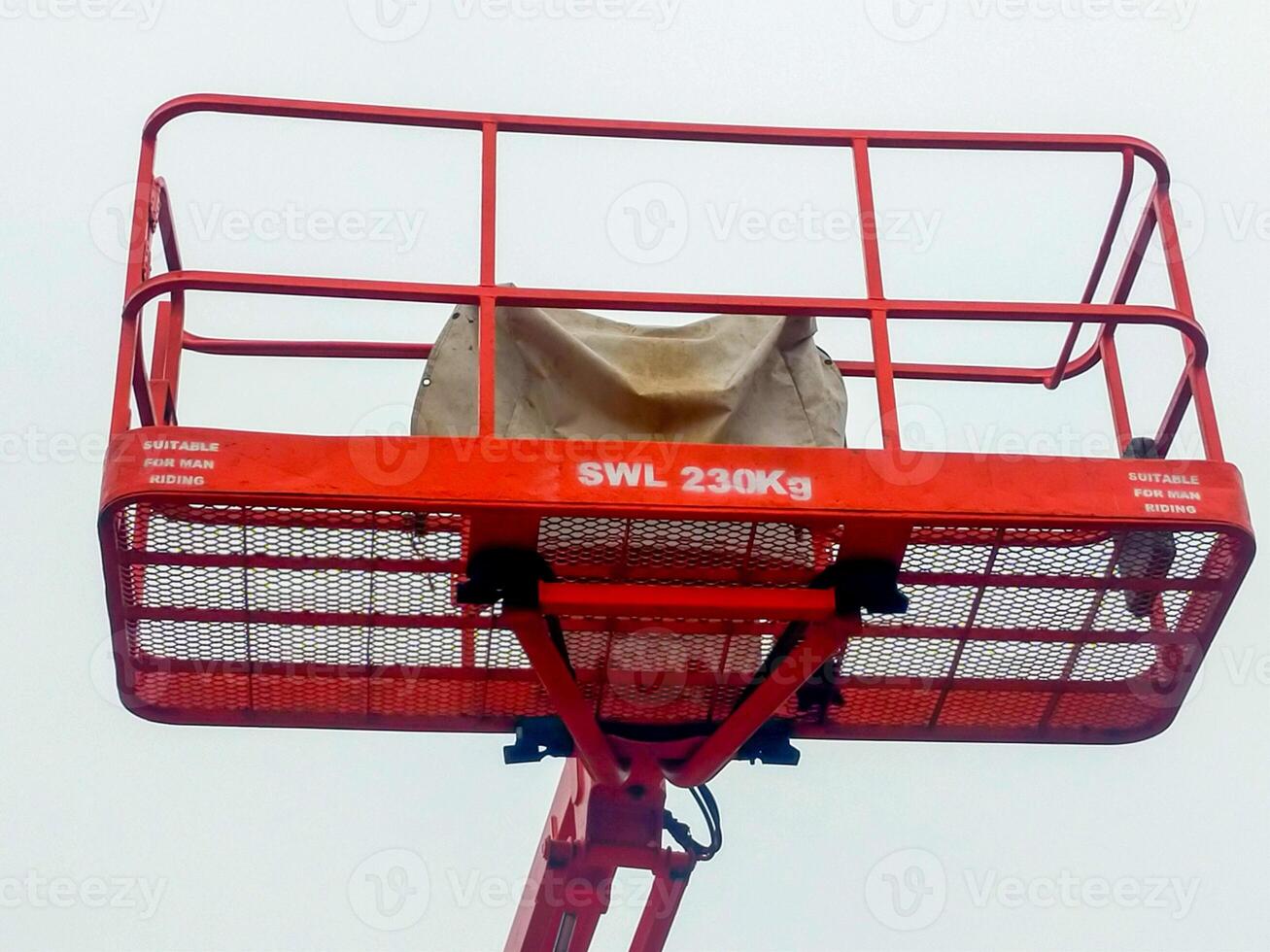 Orange boom lift platform with safety working weight 230 kg. photo