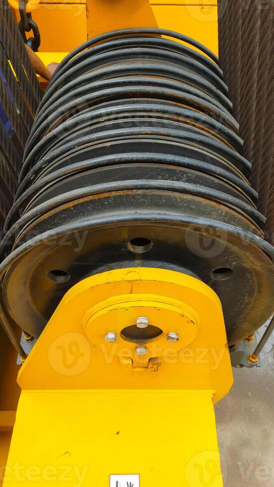 Wire sling on crane pulley block located at upper rear platform of the most crane. photo