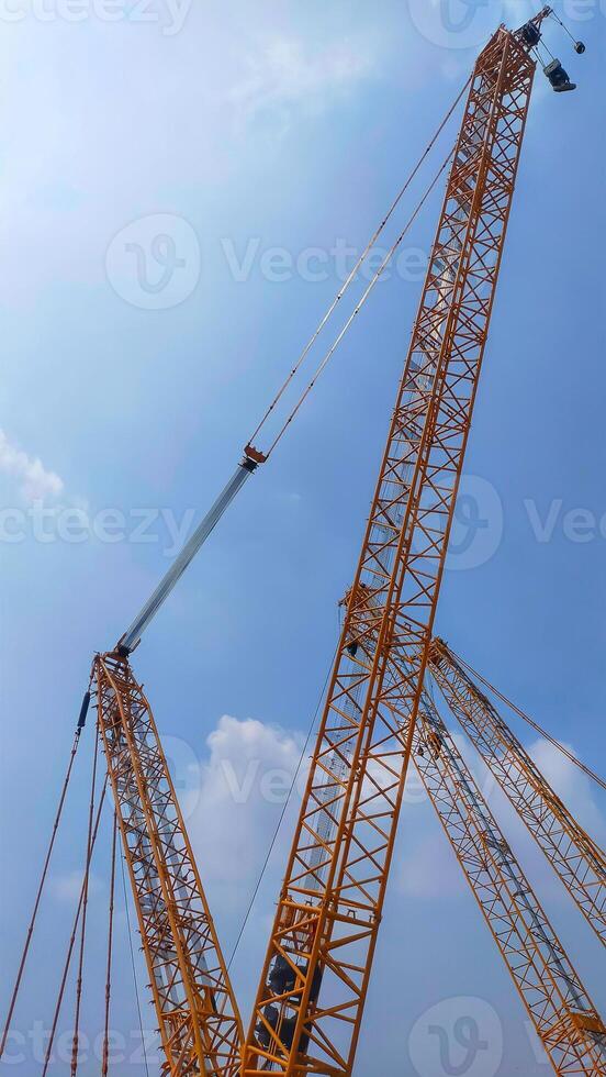 Top boom of crawler crane rise to the sky. photo