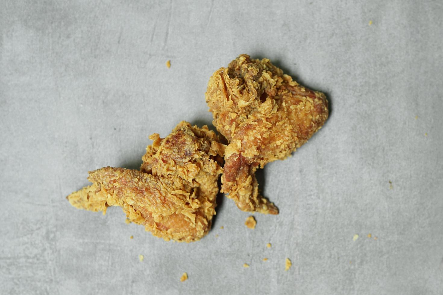 Fried chicken wings ready to eat on a concrete background photo