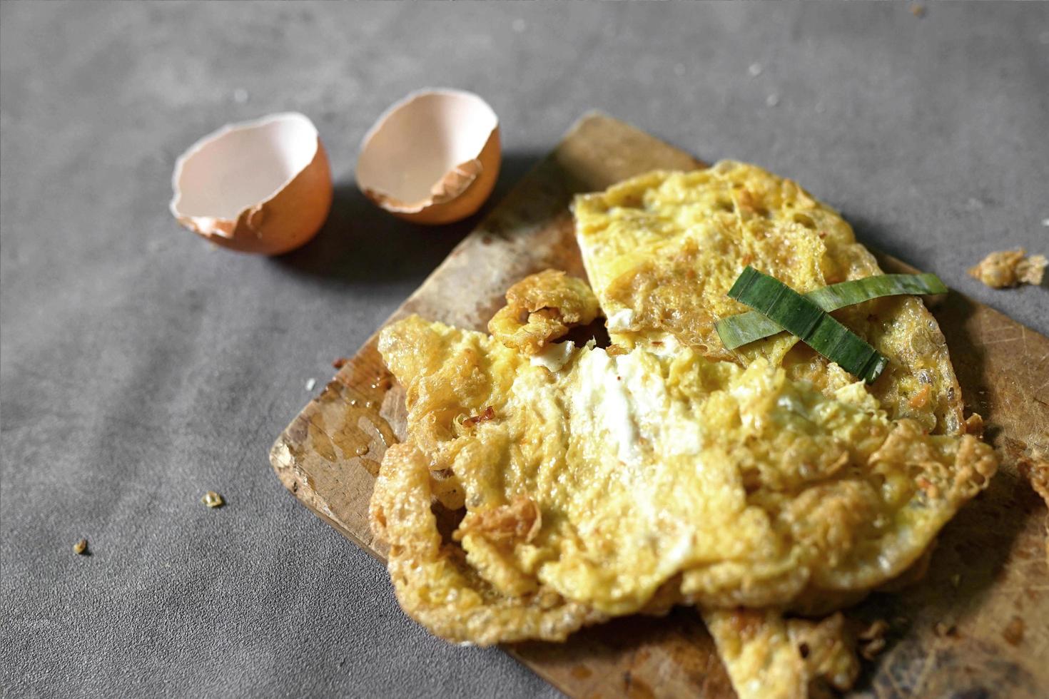 omelette on a cutting board with a concrete background photo