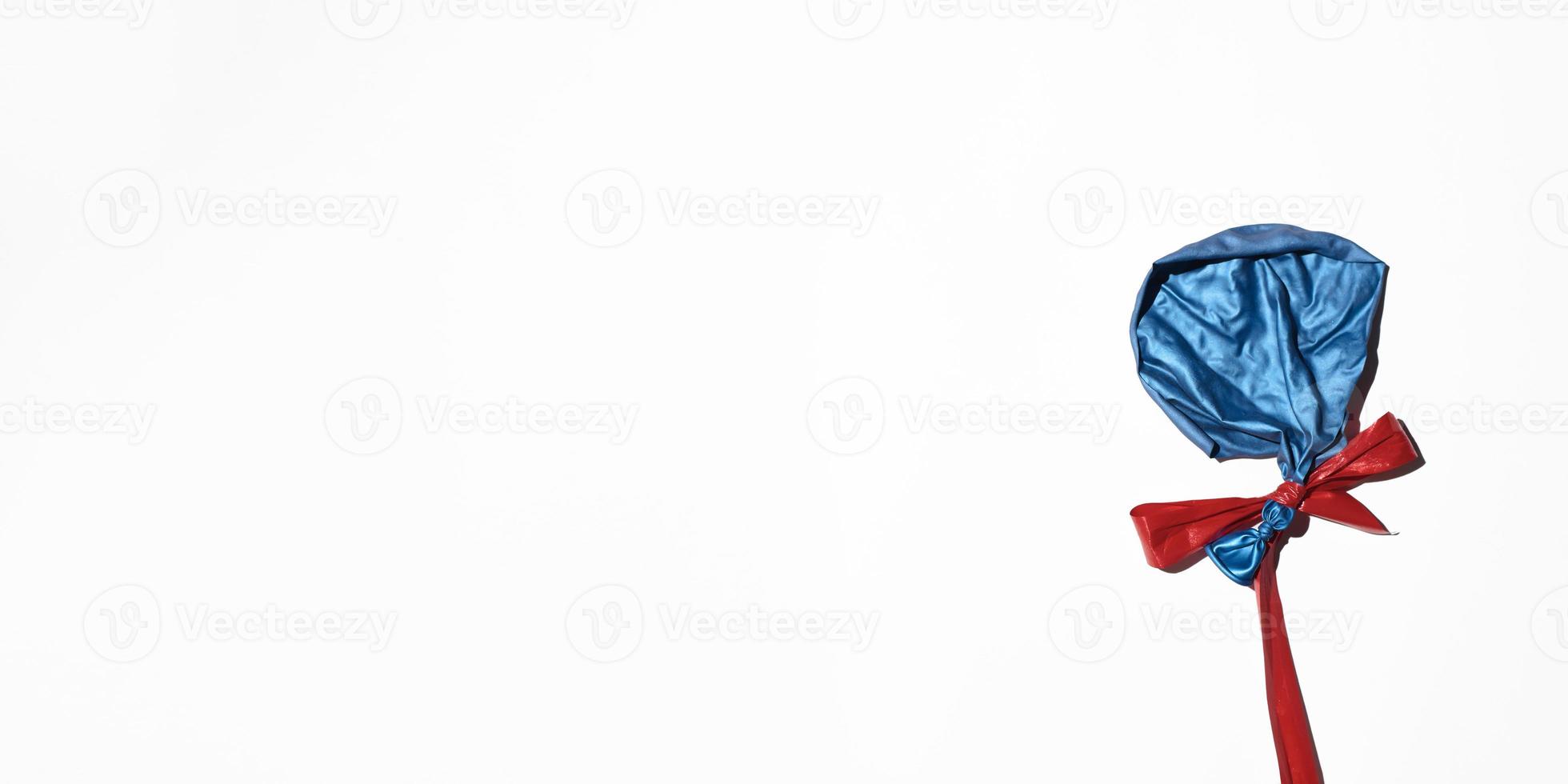 Burst balloon with red ribbon on white background, flat layout. Banner, copy space. End of the party concept, sad holiday photo