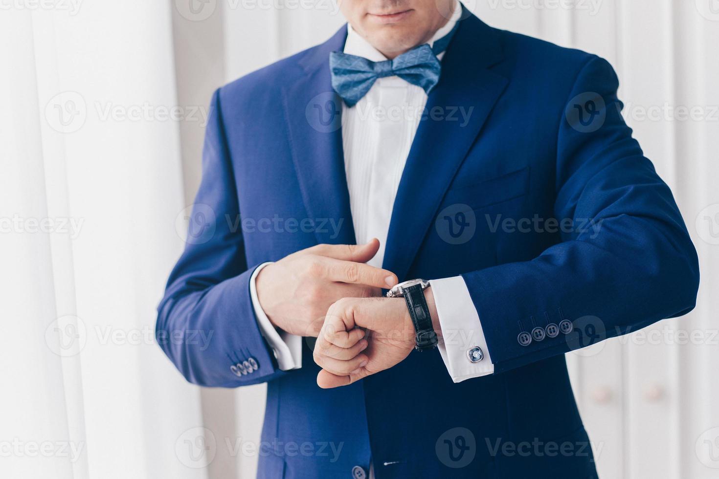 looking at luxury watch on hand check the time.businessman concept for managing time organization working,punctuality,appointment.fashionable wearing stylish photo