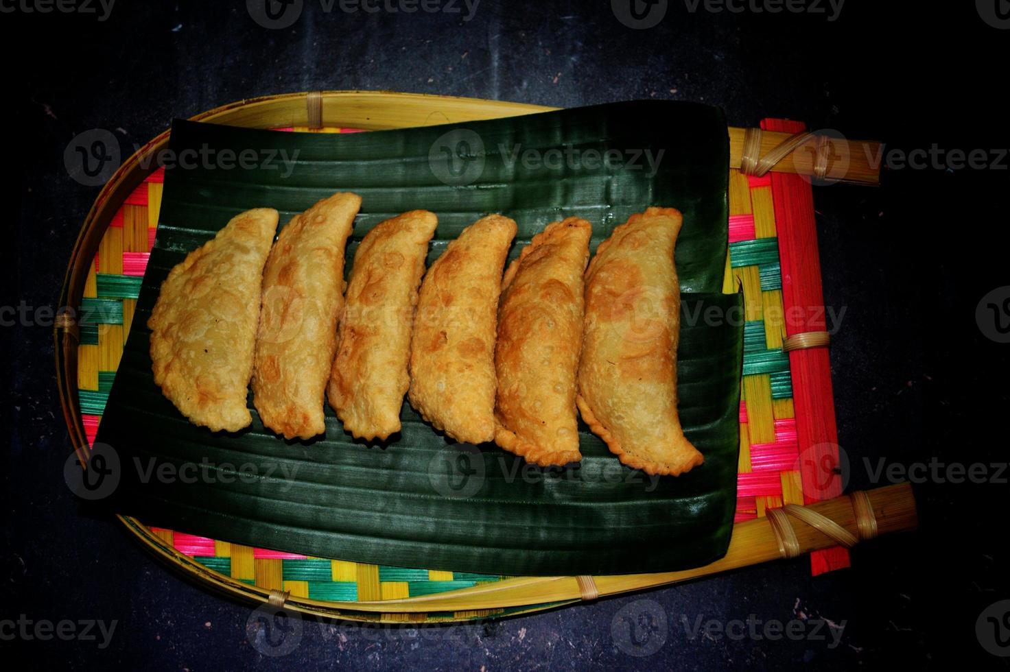 Asian Traditional Food Jhal Puli Pitha. Location - Bogura, Bangladesh. Date - 24 November 2022 photo