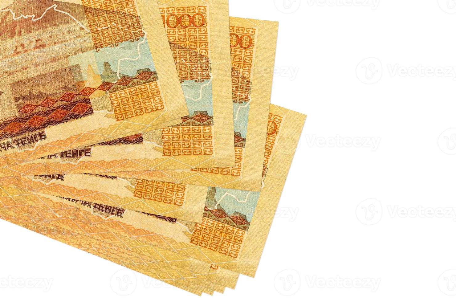 1000 Kazakhstani tenge bills lies in small bunch or pack isolated on white. Mockup with copy space. Business and currency exchange photo