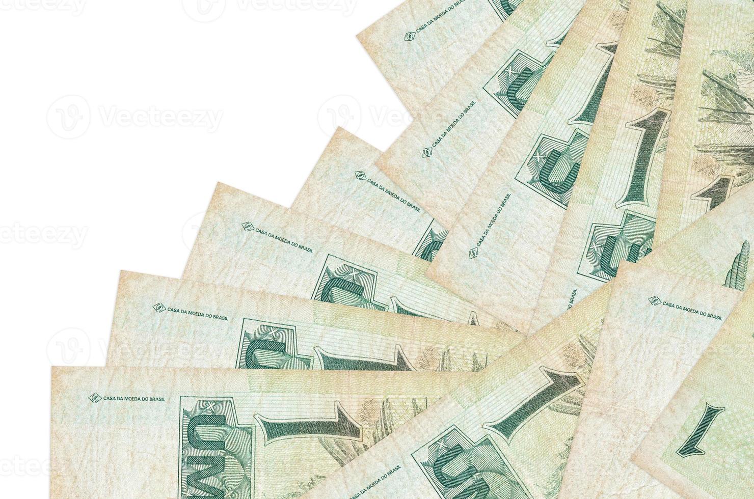 1 Brazilian real bills lies in different order isolated on white. Local banking or money making concept photo