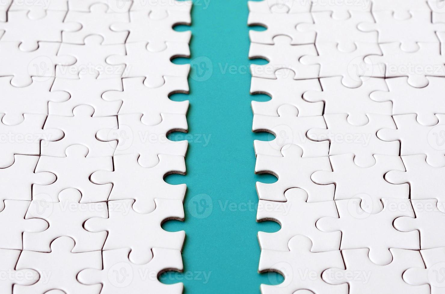 The blue path is laid on the platform of a white folded jigsaw puzzle. Texture image with copy space for text photo