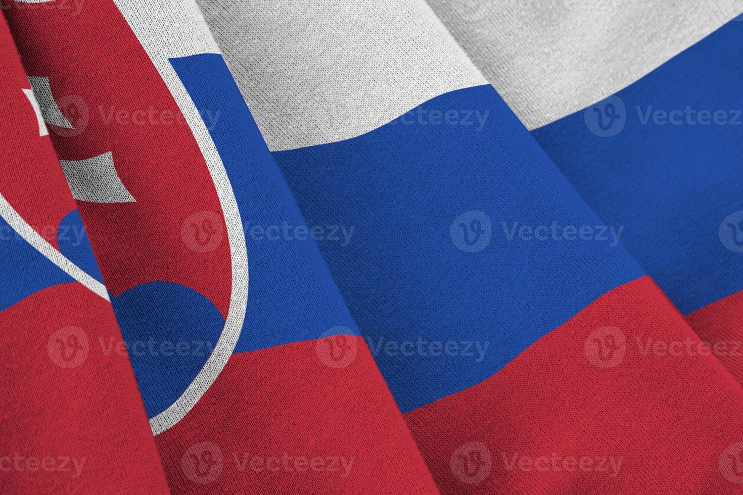 Slovakia flag with big folds waving close up under the studio light indoors. The official symbols and colors in banner photo