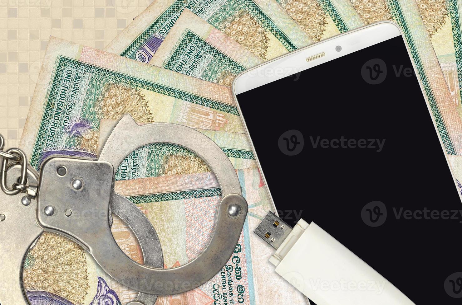 1000 Sri Lankan rupees bills and smartphone with police handcuffs. Concept of hackers phishing attacks, illegal scam or malware soft distribution photo