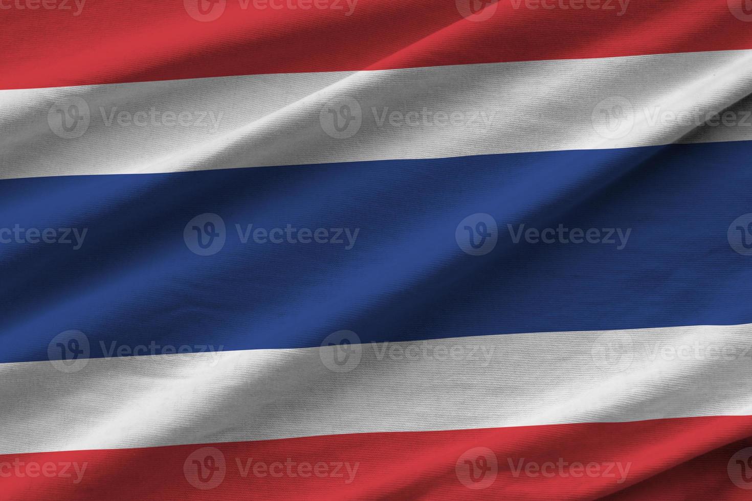 Thailand flag with big folds waving close up under the studio light indoors. The official symbols and colors in banner photo
