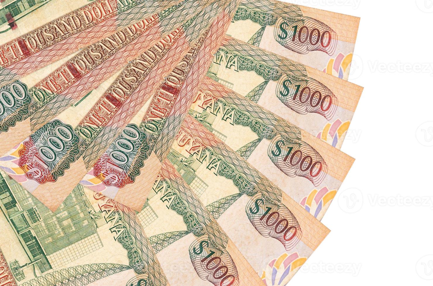 1000 Guyanese dollars bills lies isolated on white background with copy space stacked in fan shape close up photo
