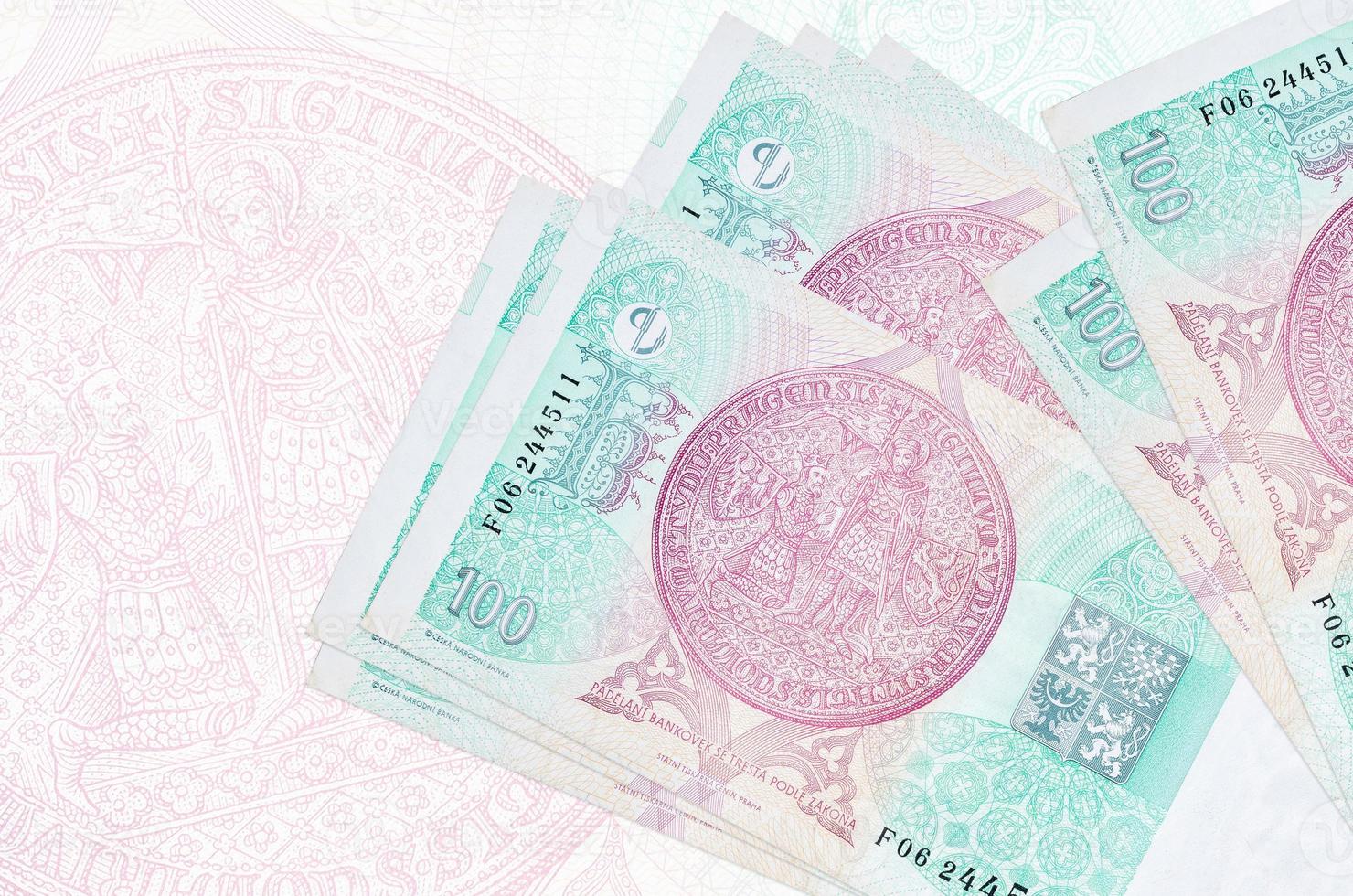 100 Czech korun bills lies in stack on background of big semi-transparent banknote. Abstract presentation of national currency photo