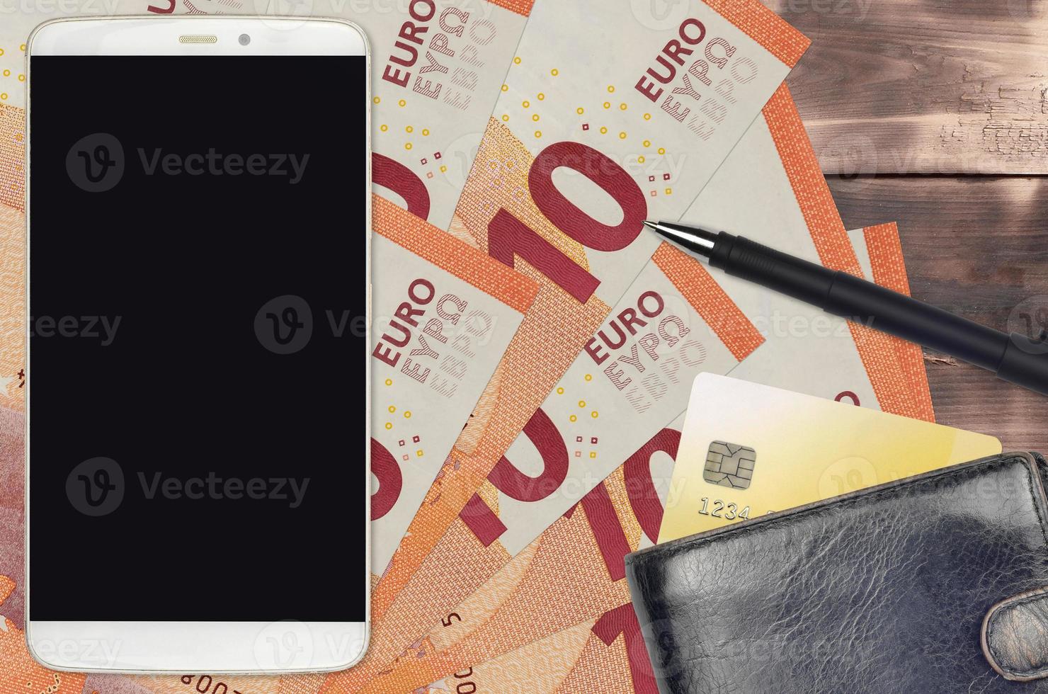 10 euro bills and smartphone with purse and credit card. E-payments or e-commerce concept. Online shopping and business with portable devices photo