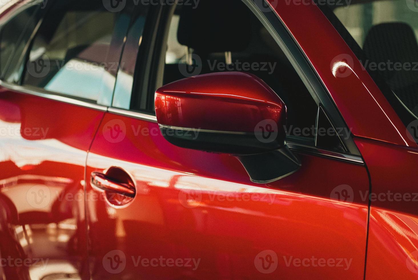 Red car in dealership showroom, new cars sale, automotive background photo