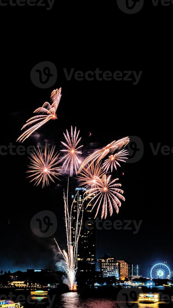 fireworks celebration on the river in the dark sky photo