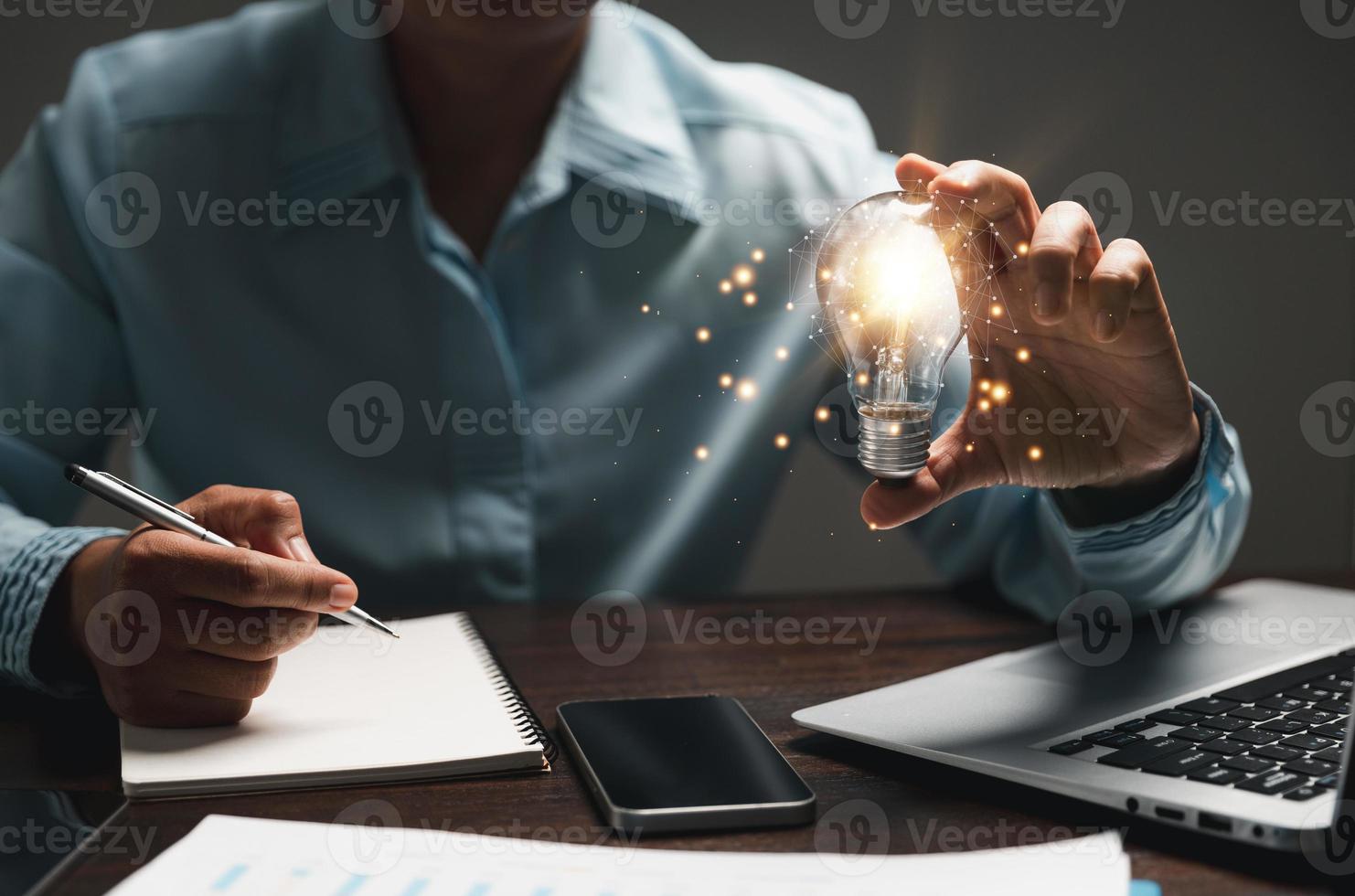 Hand of woman with light bulb and there is gear icon and using laptop computer. Innovation idea concept. Concept of brainstorming inspiration creatively. photo