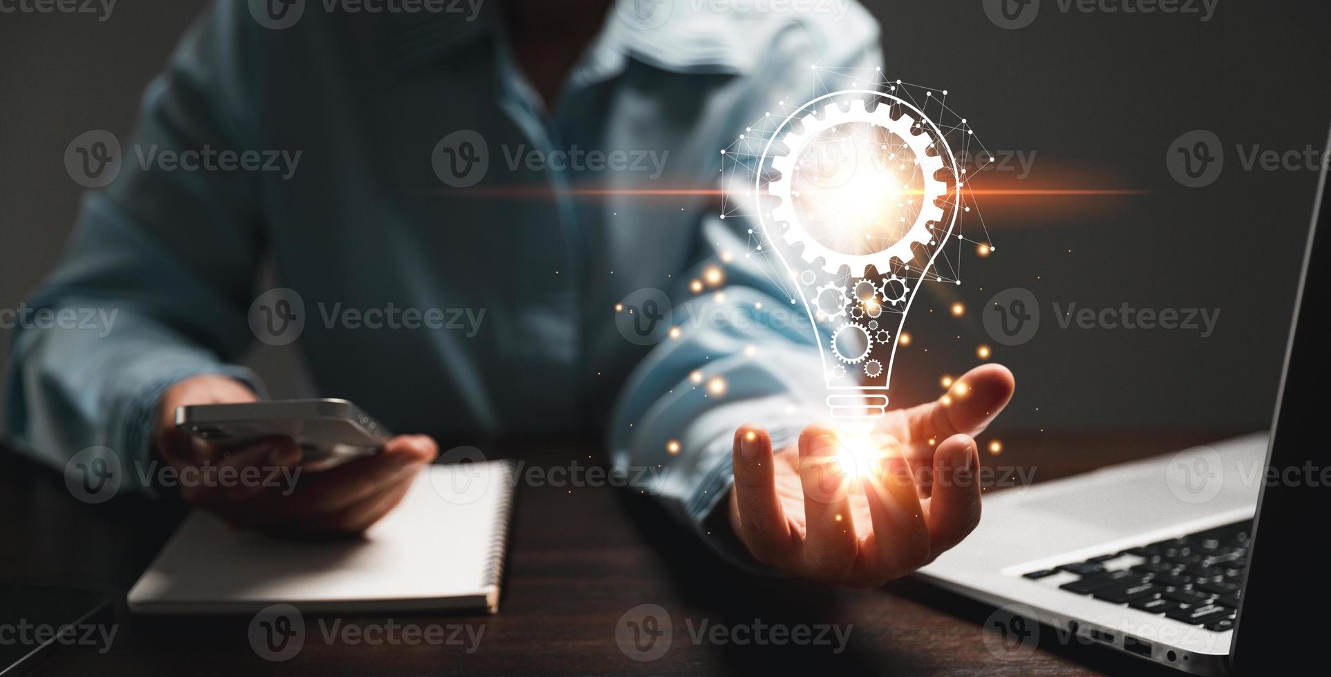Hand of woman with light bulb and there is gear icon and using laptop computer. Innovation idea concept. Concept of brainstorming inspiration creatively. photo