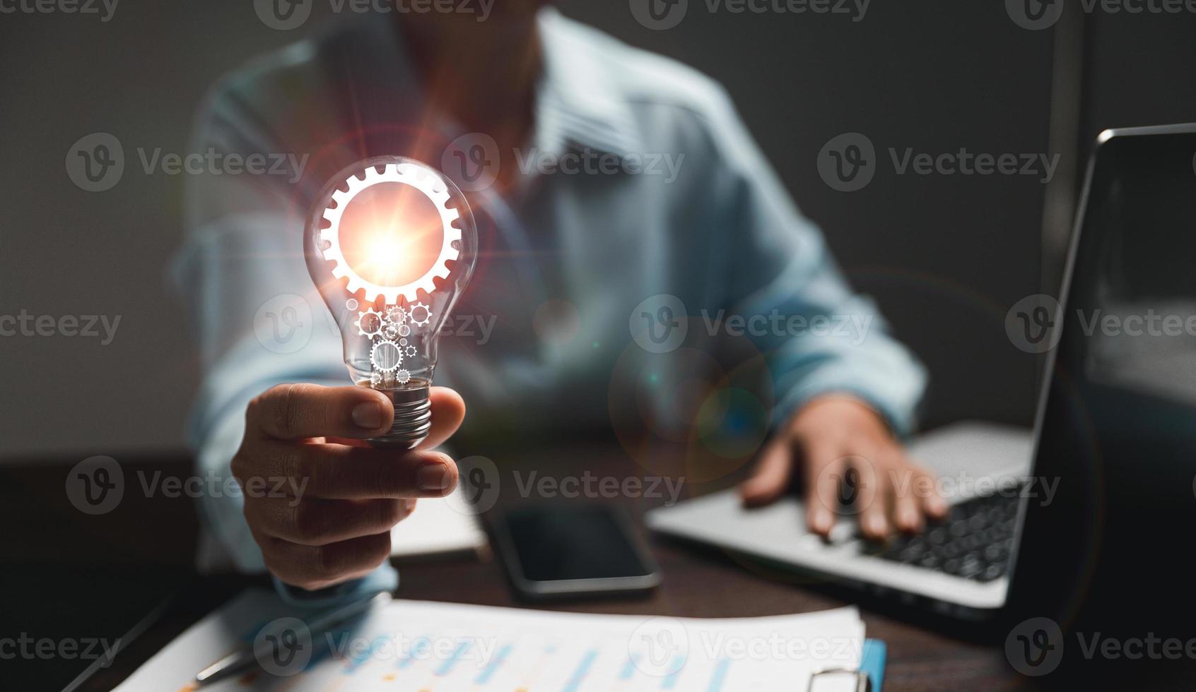 Hand of woman with light bulb and there is gear icon and using laptop computer. Innovation idea concept. Concept of brainstorming inspiration creatively. photo