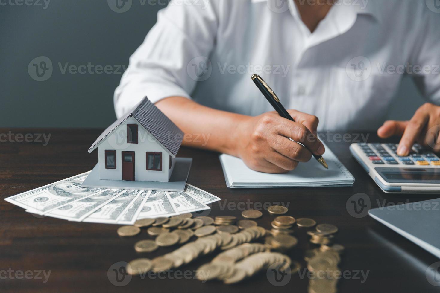 Saving investment home with loan finance money business concept. Investment banking finance for residential real estate business. Stack coins with model house for investment loans.Cash for taxes. photo