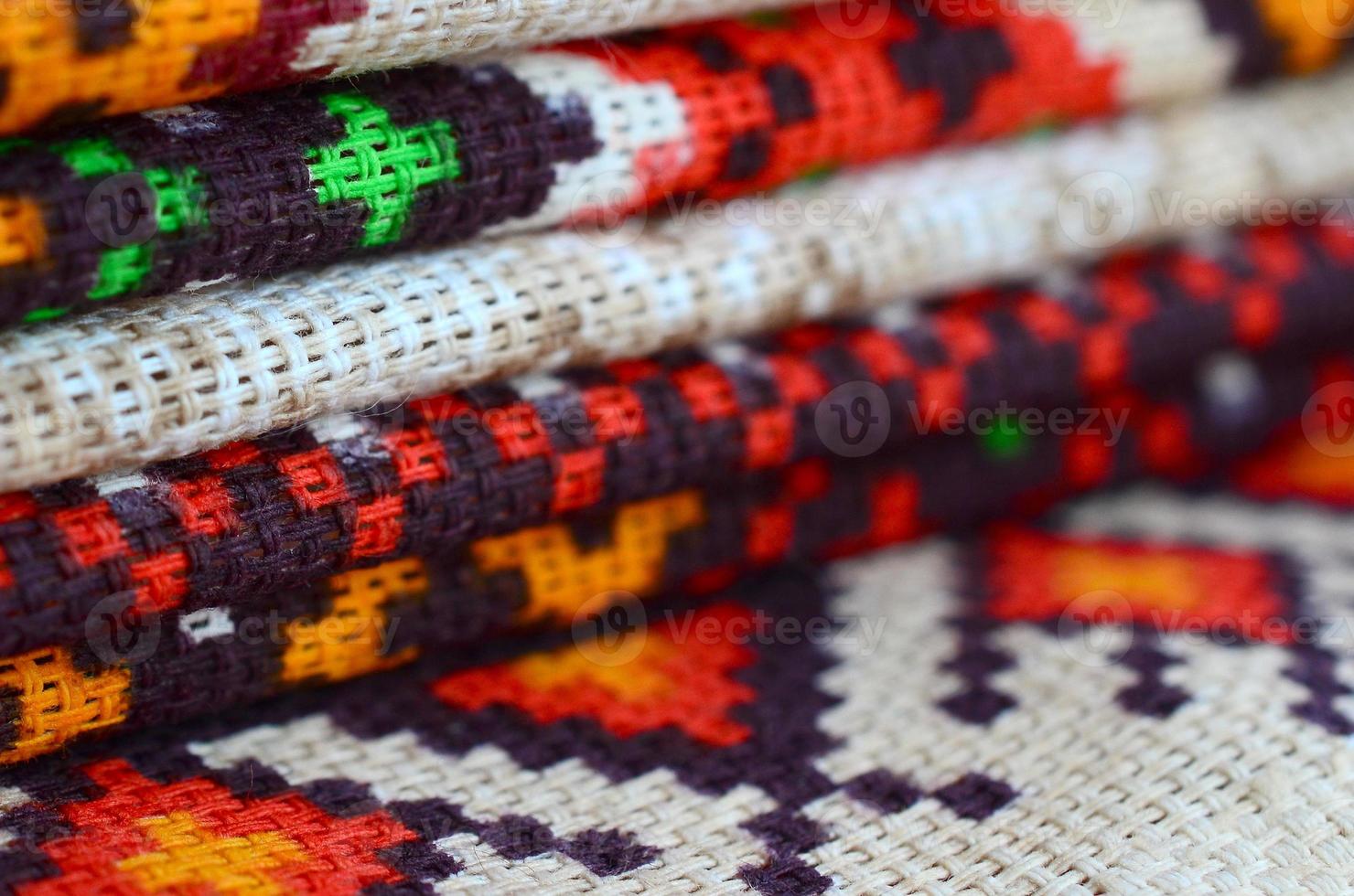 Stack of traditional Ukrainian folk art knitted embroidery patterns on textile fabric photo