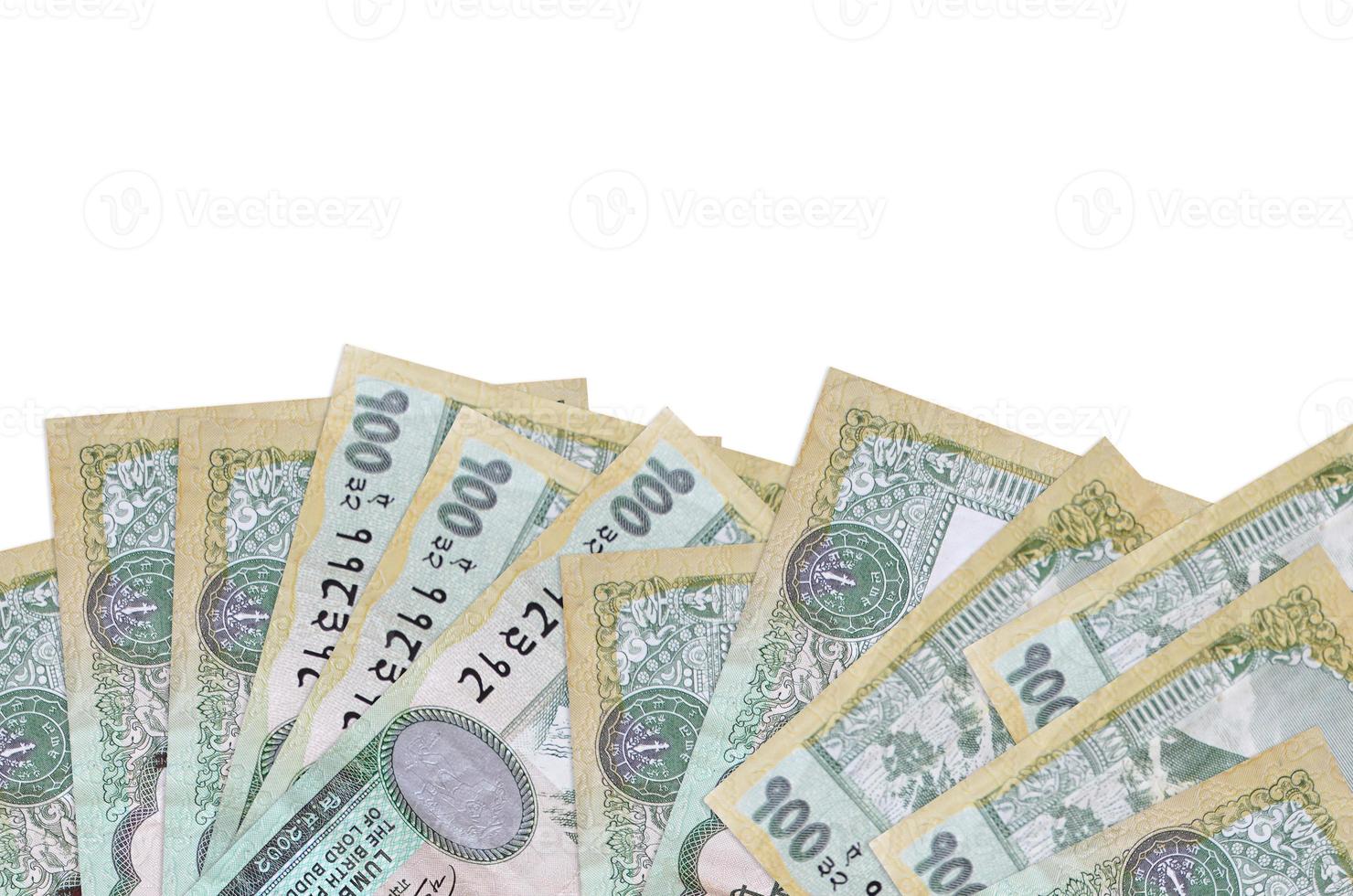 100 Nepalese rupees bills lies on bottom side of screen isolated on white background with copy space. Background banner template photo