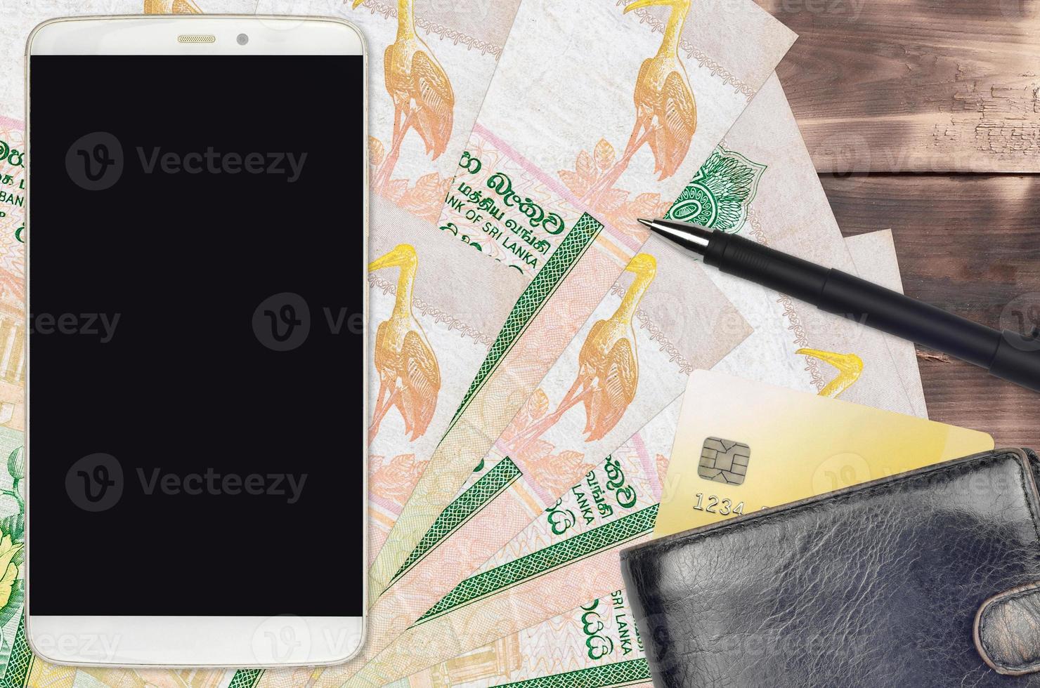 10 Sri Lankan rupees bills and smartphone with purse and credit card. E-payments or e-commerce concept. Online shopping and business with portable devices photo