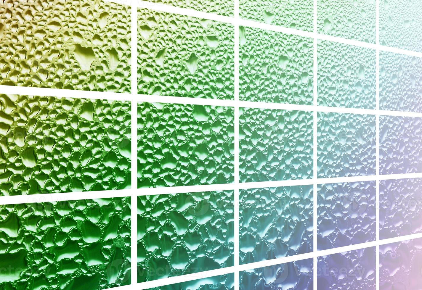 A collage of many different fragments of glass, decorated with rain drops from the condensate. Rainbow colors photo