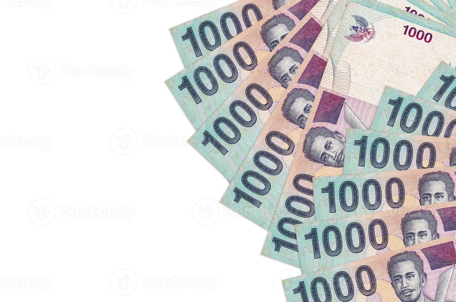 1000 Indonesian rupiah bills lies isolated on white background with copy space. Rich life conceptual background photo