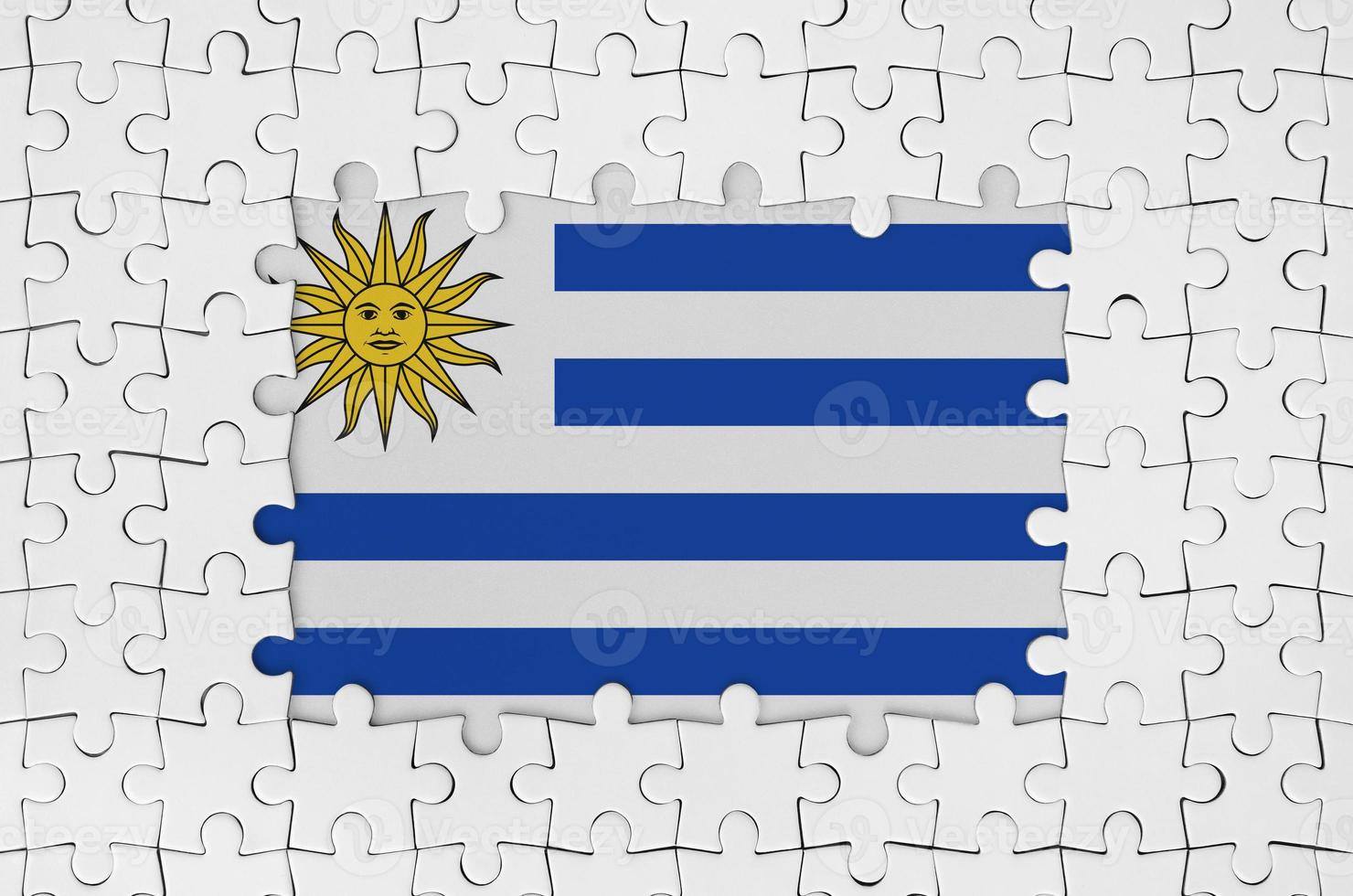 Uruguay flag in frame of white puzzle pieces with missing central part photo