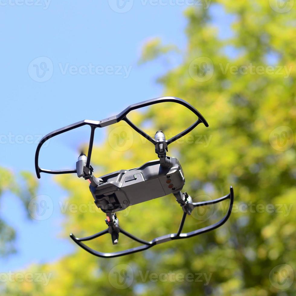 Drone with photocamera take off from land and flying for take aerial photo