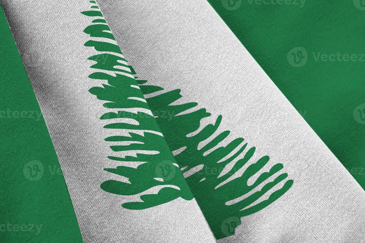 Norfolk island flag with big folds waving close up under the studio light indoors. The official symbols and colors in banner photo