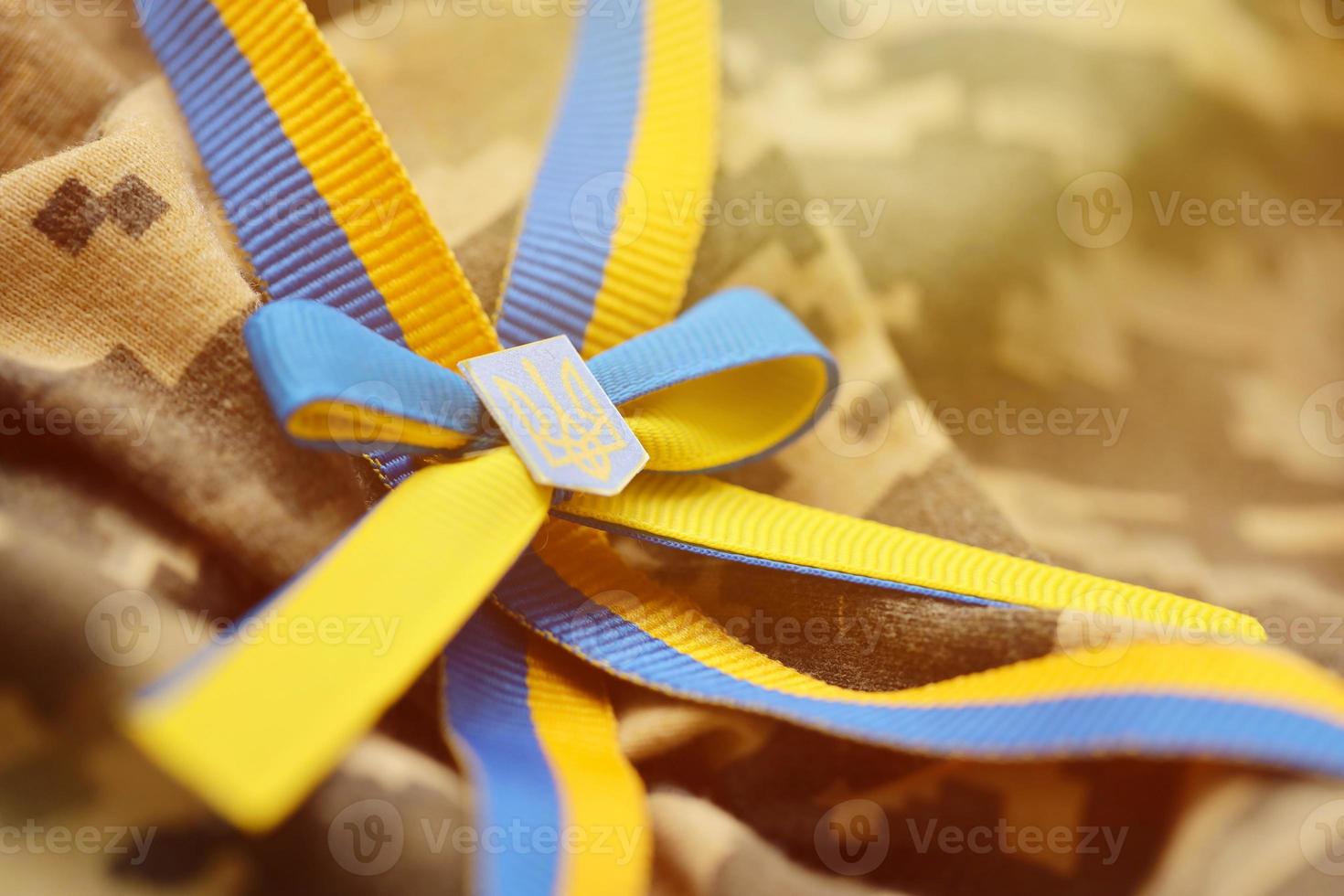 Military camouflage fabric with ukrainian stripes on ribbon photo