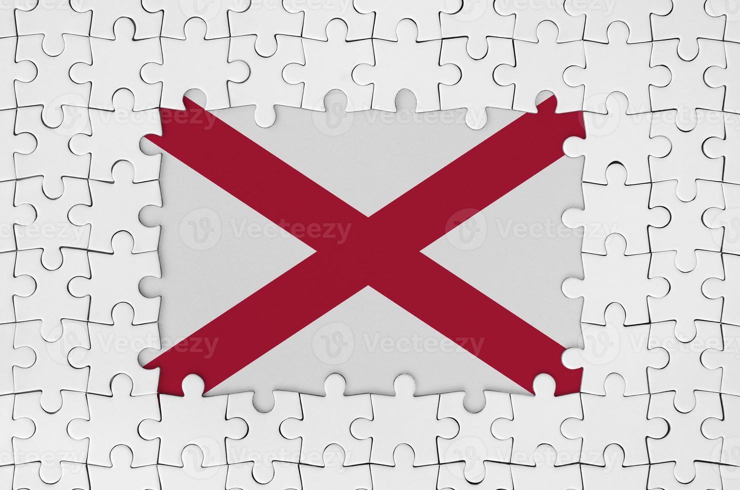 Alabama US state flag in frame of white puzzle pieces with missing central part photo