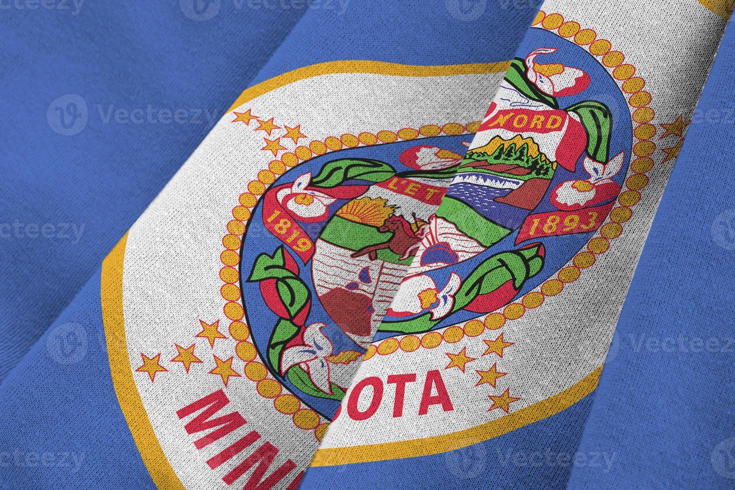 Minnesota US state flag with big folds waving close up under the studio light indoors. The official symbols and colors in banner photo