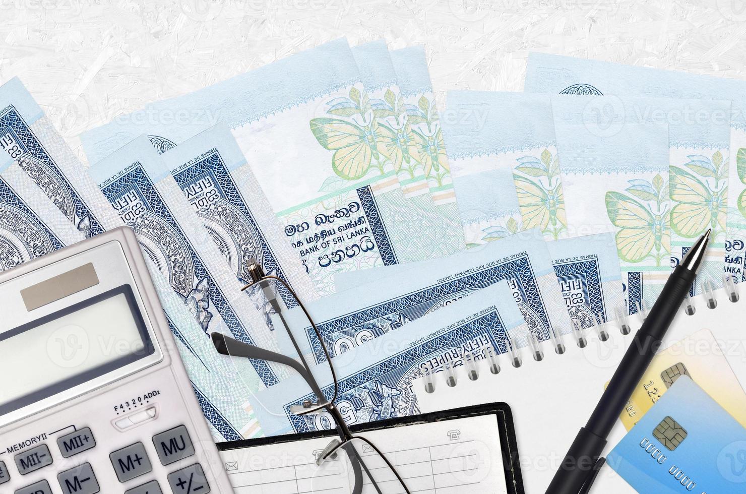 50 Sri Lankan rupees bills and calculator with glasses and pen. Tax payment concept or investment solutions. Financial planning or accountant paperwork photo