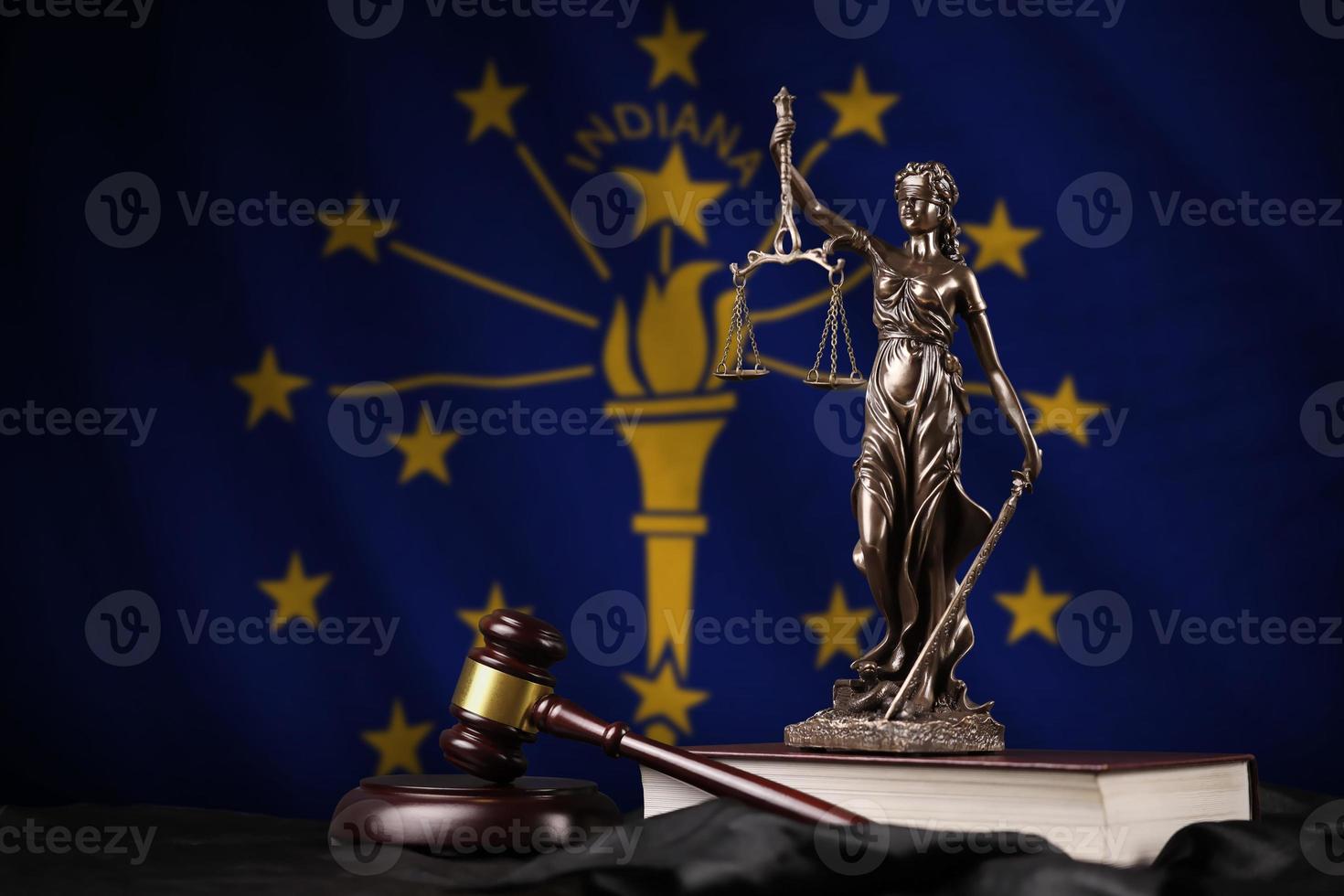 Indiana US state flag with statue of lady justice, constitution and judge hammer on black drapery. Concept of judgement and guilt photo