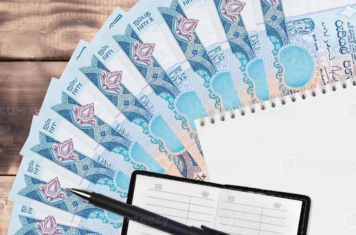 50 Sri Lankan rupees bills fan and notepad with contact book and black