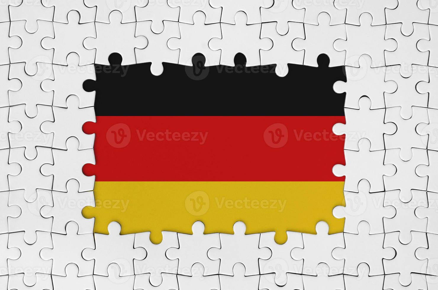 Germany flag in frame of white puzzle pieces with missing central part photo