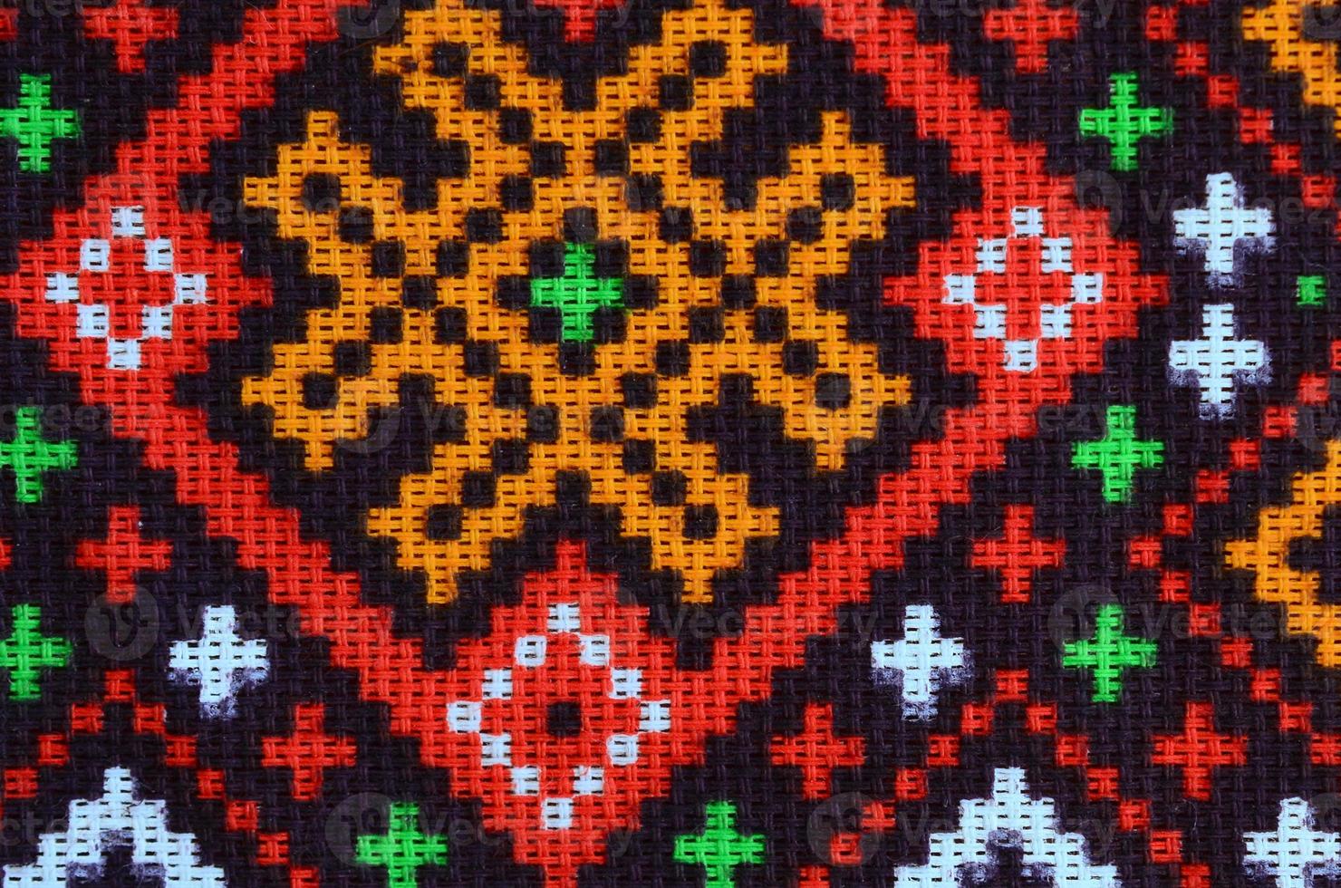 Traditional Ukrainian folk art knitted embroidery pattern on textile fabric photo