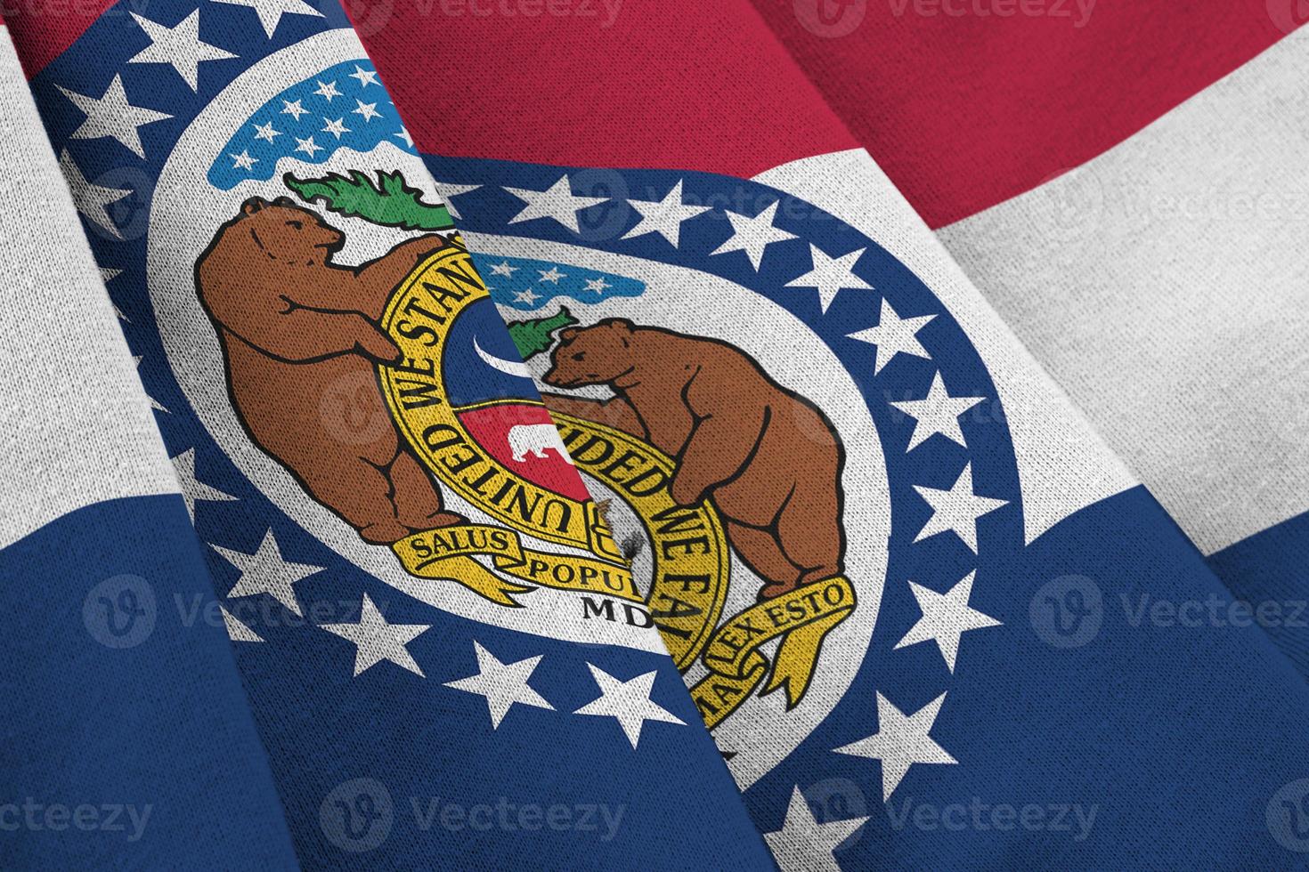 Missouri US state flag with big folds waving close up under the studio light indoors. The official symbols and colors in banner photo